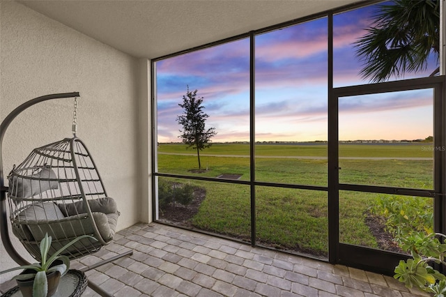 unfurnished sunroom with a rural view