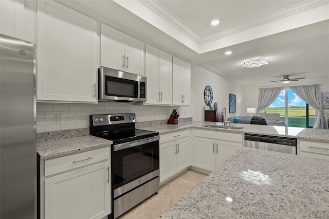 kitchen featuring ceiling fan, sink, white cabinetry, and stainless steel appliances