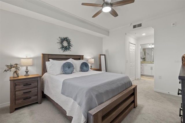 bedroom featuring light carpet, ensuite bathroom, ceiling fan, and crown molding