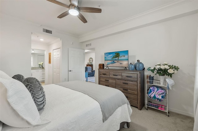 carpeted bedroom with a closet, ensuite bathroom, ceiling fan, and ornamental molding