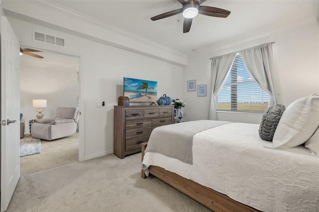 carpeted bedroom with ceiling fan and ornamental molding