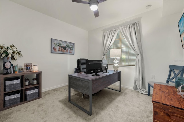 office space featuring ceiling fan and light carpet