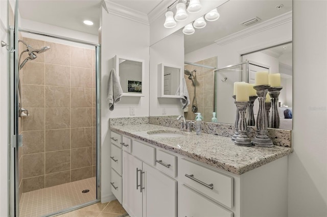 bathroom featuring vanity, tile patterned floors, an enclosed shower, and ornamental molding