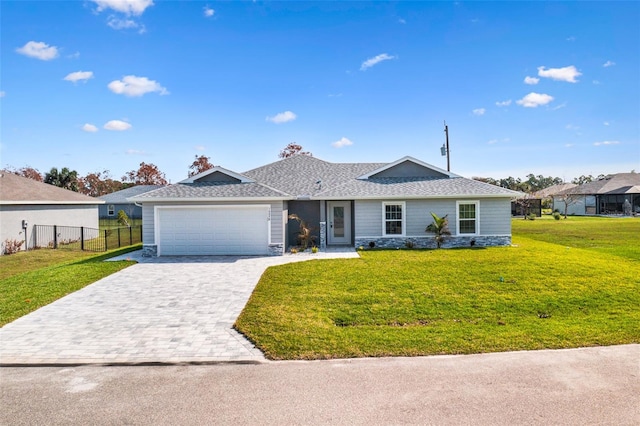 ranch-style home with a front lawn and a garage