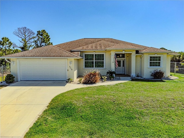 view of front of property with a front yard and a garage