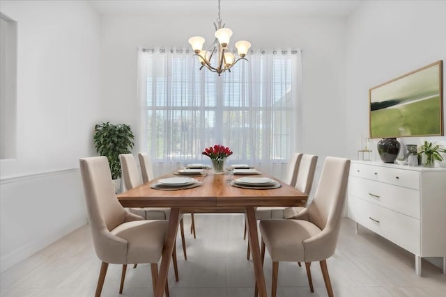 dining space with light tile patterned flooring, a healthy amount of sunlight, and a chandelier