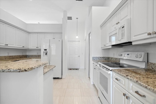 kitchen featuring white cabinets, light tile patterned floors, light stone countertops, decorative light fixtures, and white appliances