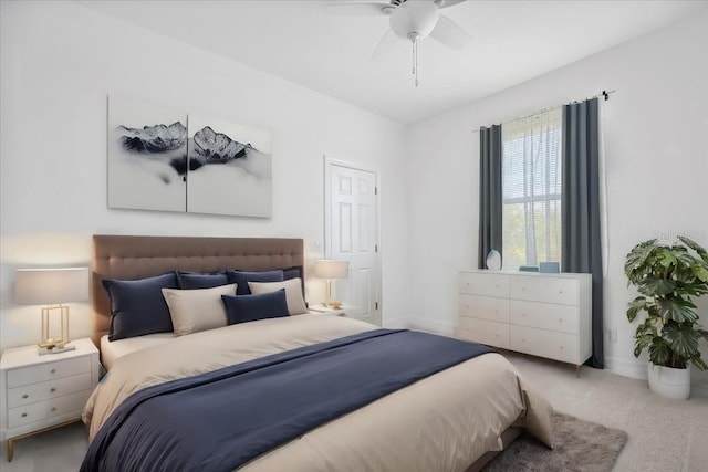 carpeted bedroom featuring baseboards and a ceiling fan