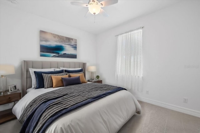 carpeted bedroom featuring baseboards and ceiling fan