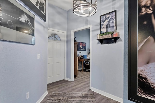 corridor with a chandelier and wood-type flooring