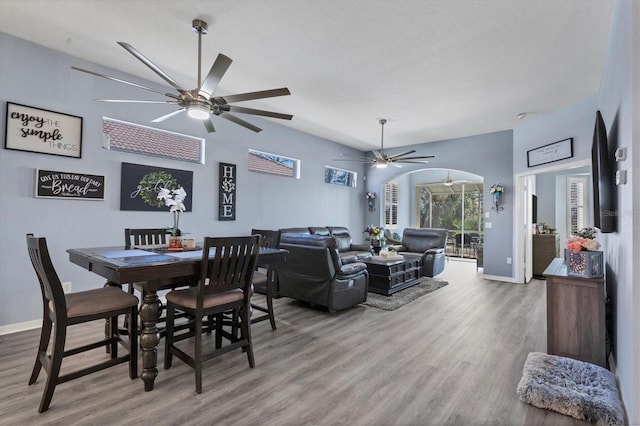 dining area with wood-type flooring and ceiling fan