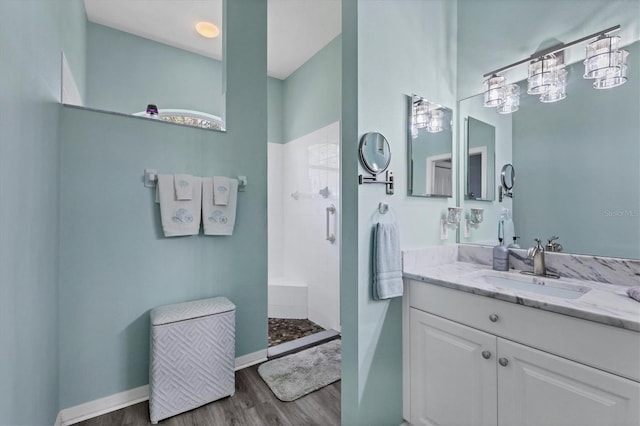 bathroom with vanity, a shower, and wood-type flooring