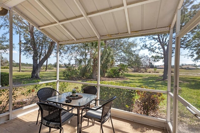 sunroom / solarium featuring a wealth of natural light and vaulted ceiling