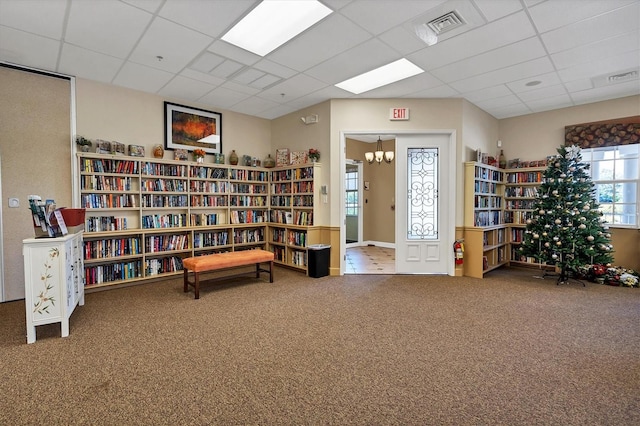 sitting room featuring a paneled ceiling and carpet floors