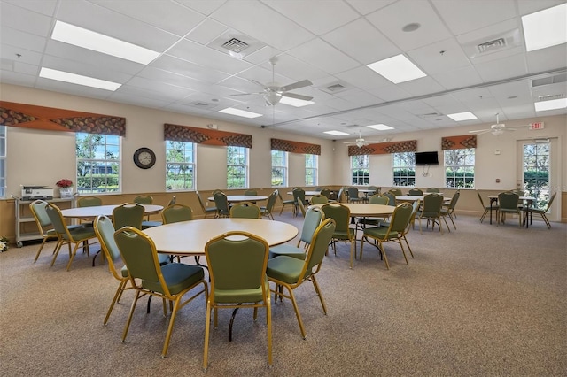 dining space featuring a drop ceiling, plenty of natural light, and ceiling fan