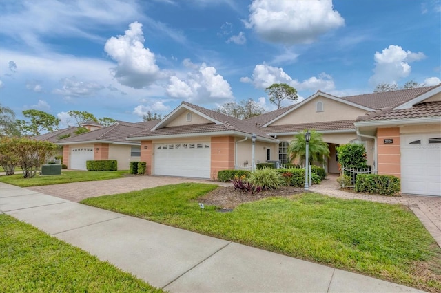 ranch-style home featuring a garage and a front lawn