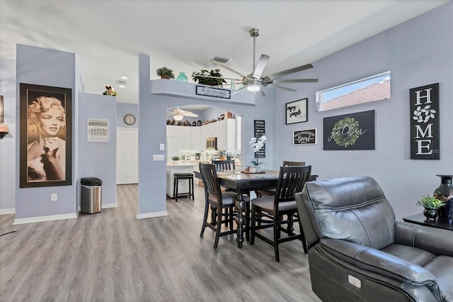 dining space featuring light hardwood / wood-style floors and ceiling fan