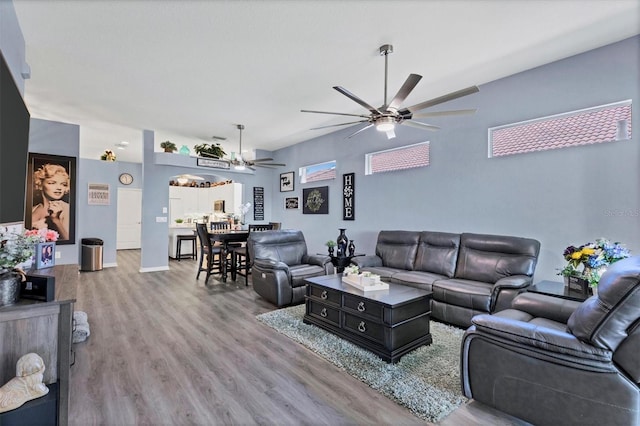 living room with light wood-type flooring and ceiling fan