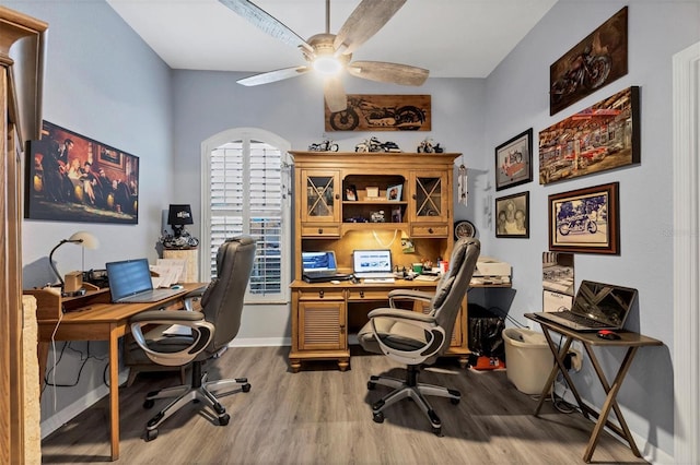 home office with hardwood / wood-style floors and ceiling fan