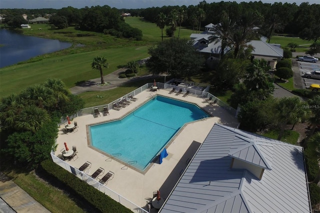 view of swimming pool with a patio area and a water view