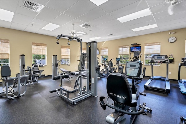 exercise room featuring a drop ceiling and ceiling fan