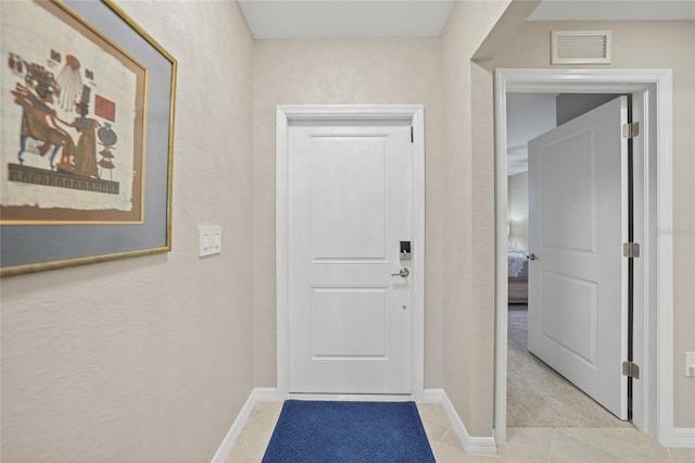 entryway with light tile patterned floors