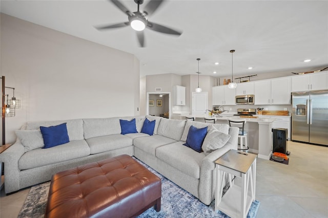 living room with light tile patterned floors and ceiling fan