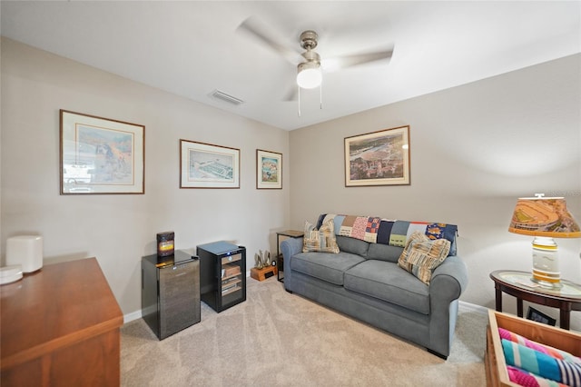 carpeted living room with ceiling fan