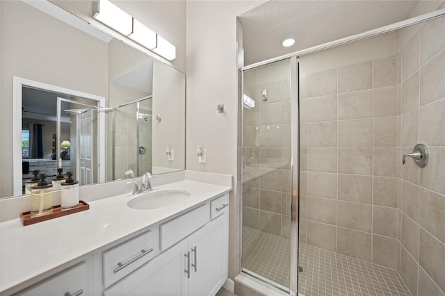 bathroom with vanity and a shower with shower door