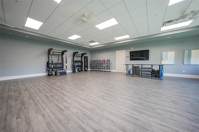 workout room with hardwood / wood-style flooring and a paneled ceiling