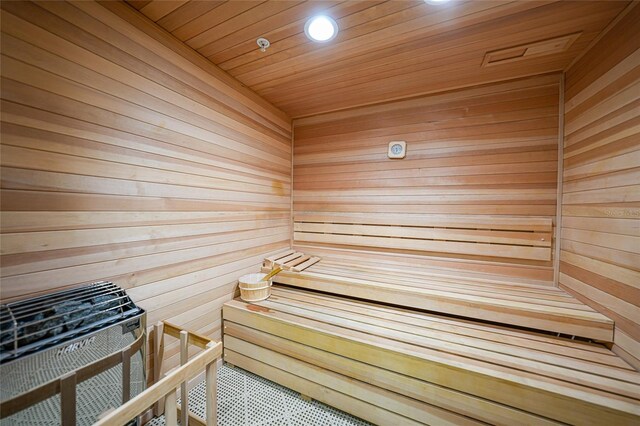 view of sauna / steam room featuring wood ceiling and wood walls