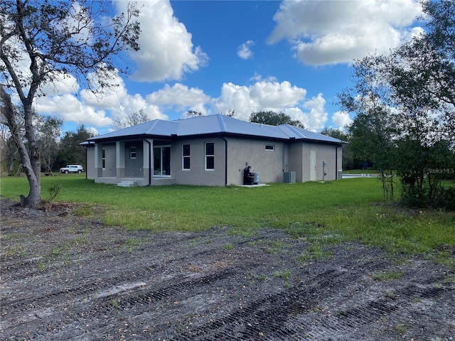 exterior space with a yard and central AC unit