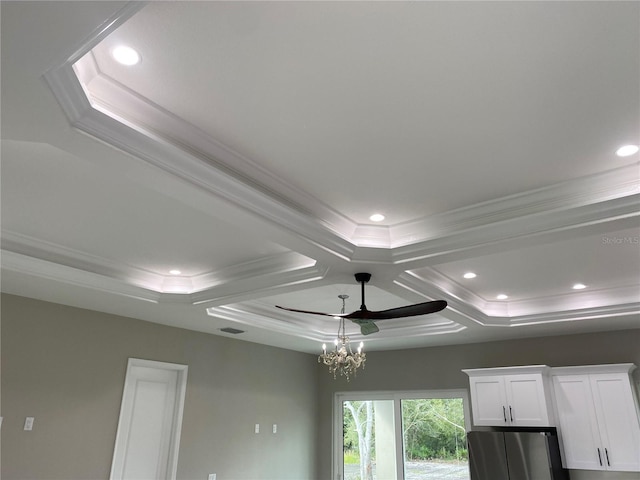 interior details with a chandelier, stainless steel fridge, ornamental molding, and coffered ceiling