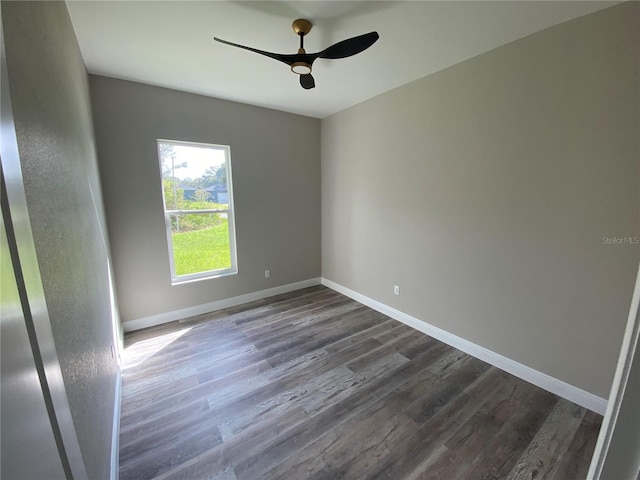 spare room with dark hardwood / wood-style floors and ceiling fan