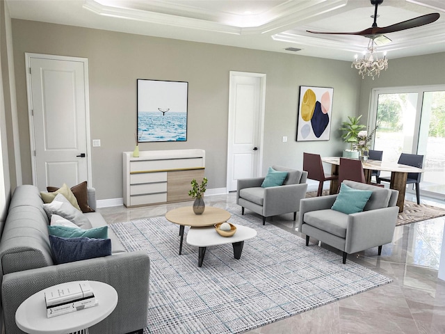 living room with a tray ceiling, ornamental molding, and an inviting chandelier