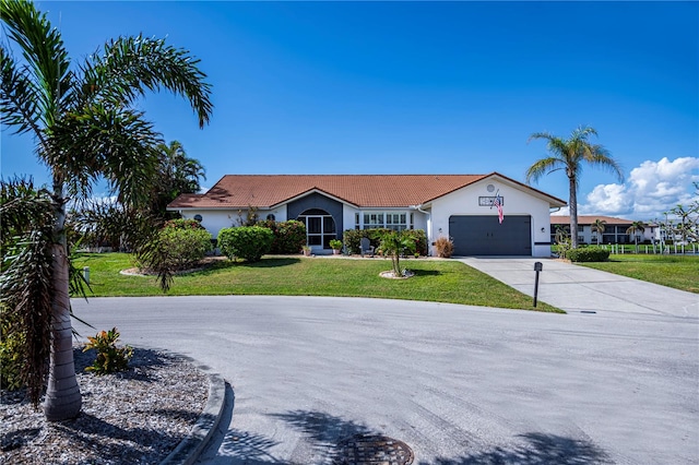 ranch-style house with a garage and a front yard