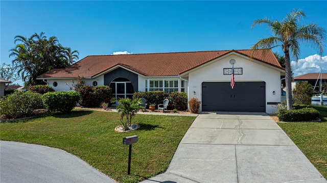 single story home featuring a front lawn and a garage