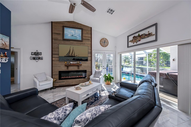 living room featuring a fireplace, ceiling fan, and lofted ceiling