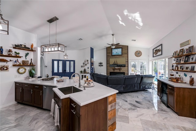 kitchen featuring french doors, vaulted ceiling, dishwasher, sink, and decorative light fixtures