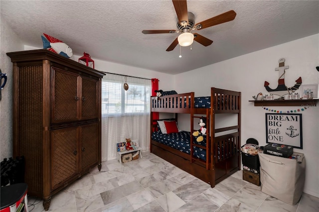 bedroom with ceiling fan and a textured ceiling