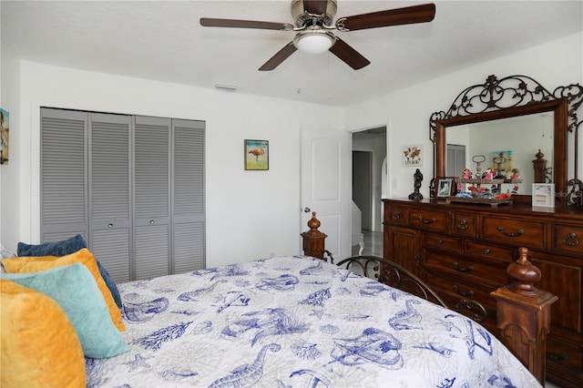 bedroom with ceiling fan and a closet