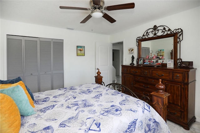 bedroom with ceiling fan and a closet