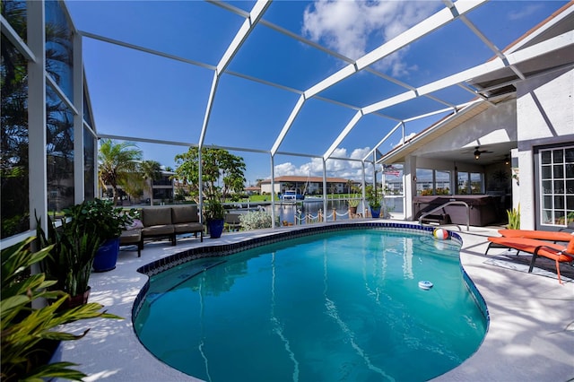 view of swimming pool with a patio area, a hot tub, glass enclosure, ceiling fan, and an outdoor hangout area