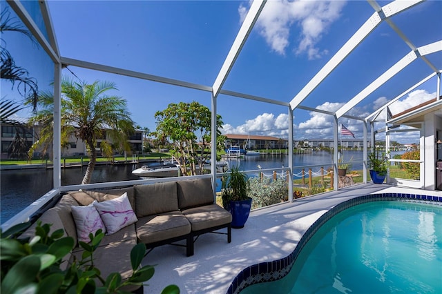 view of pool with a water view and glass enclosure