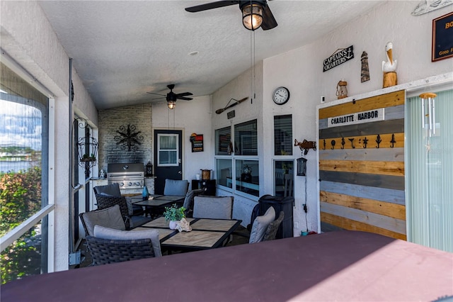 interior space featuring ceiling fan and lofted ceiling