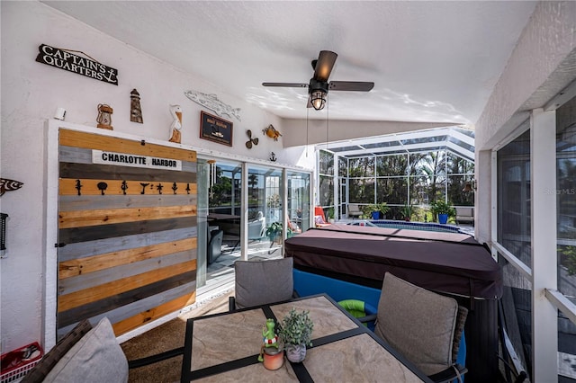 sunroom / solarium featuring a wealth of natural light, vaulted ceiling, and ceiling fan