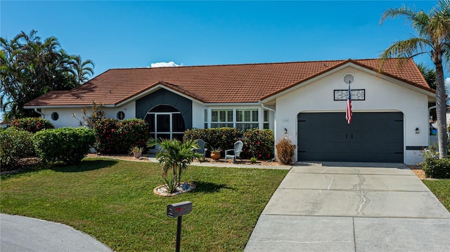 view of front facade featuring stucco siding, driveway, a tile roof, a front yard, and a garage