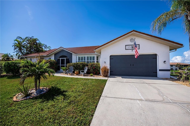 single story home featuring stucco siding, a front yard, a garage, and driveway