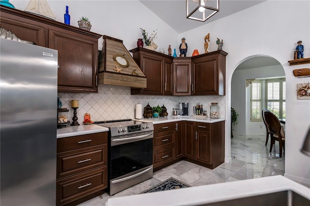 kitchen with arched walkways, light countertops, custom range hood, appliances with stainless steel finishes, and marble finish floor