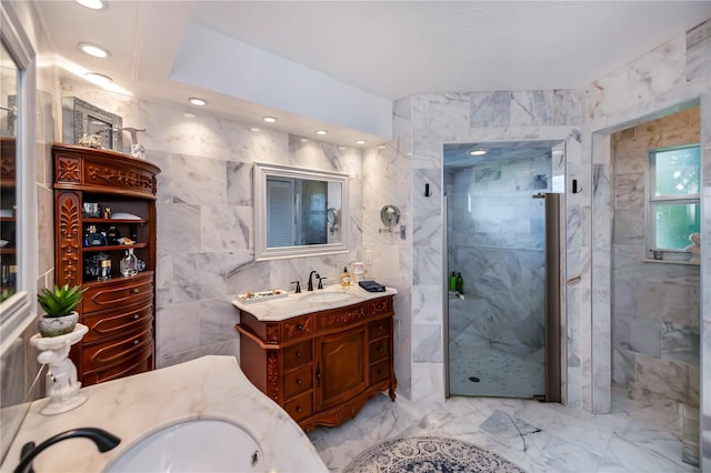 bathroom with vanity, a marble finish shower, recessed lighting, tile walls, and marble finish floor